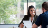 Business woman sitting at a table with a man reviewing documents