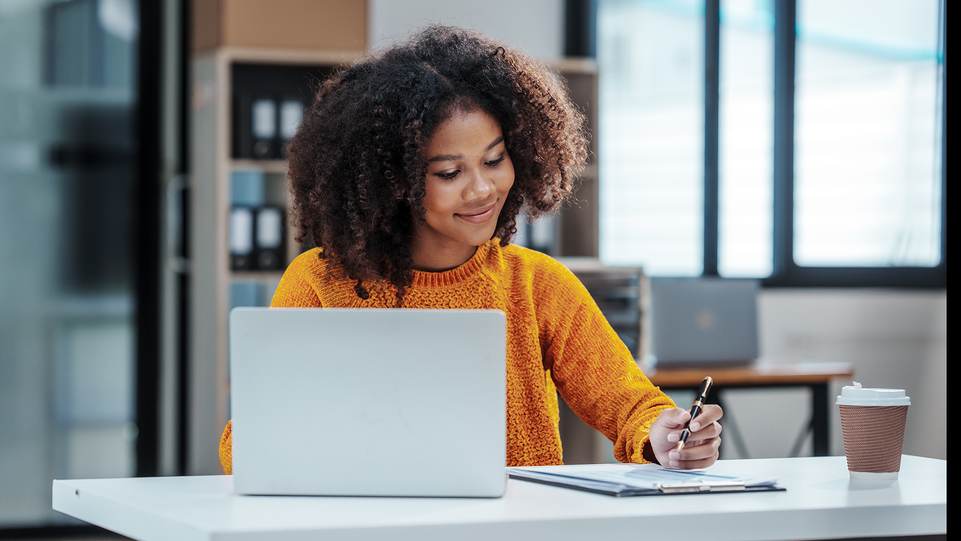 Lady at desk working on her laptop