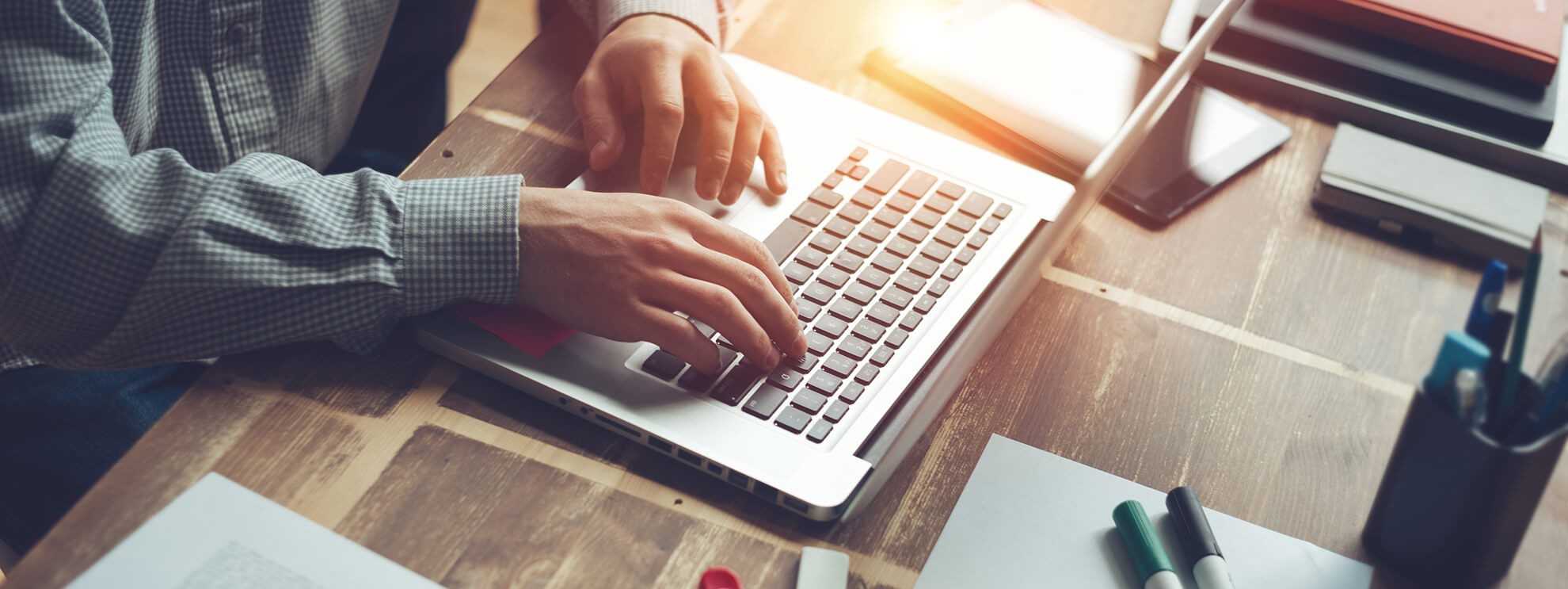 man typing on a laptop