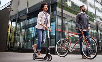couple using bike and scooter