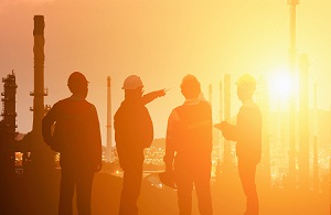 Construction team in discussion with sun setting in the dstance