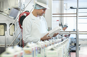 Technician checking milk on production line