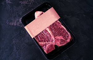 Steaks on packaging tray
