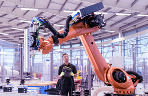 Man controlling a robot arm