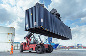 Crane lifting large shipping container