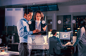 man and woman looking at ipad