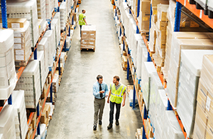 Two men walking through a warehouse
