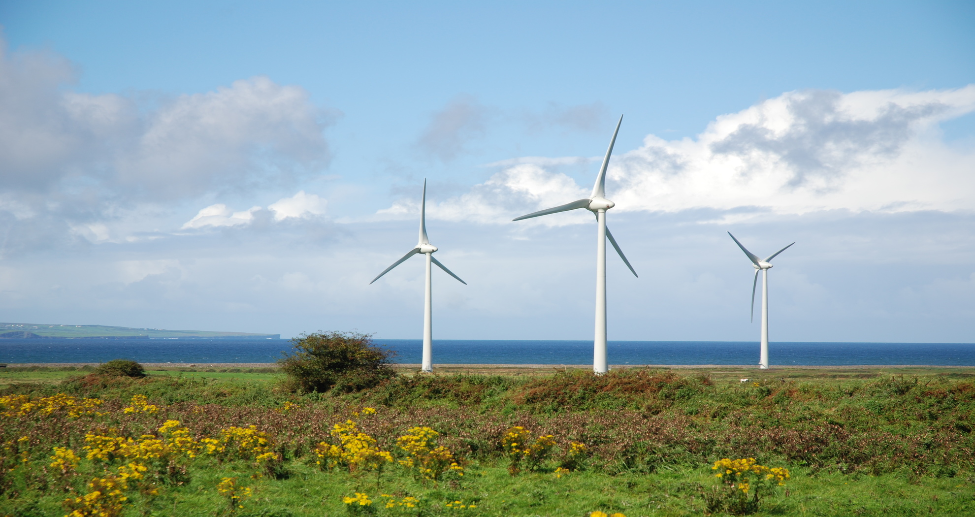View of wind turbines with the sea in the background