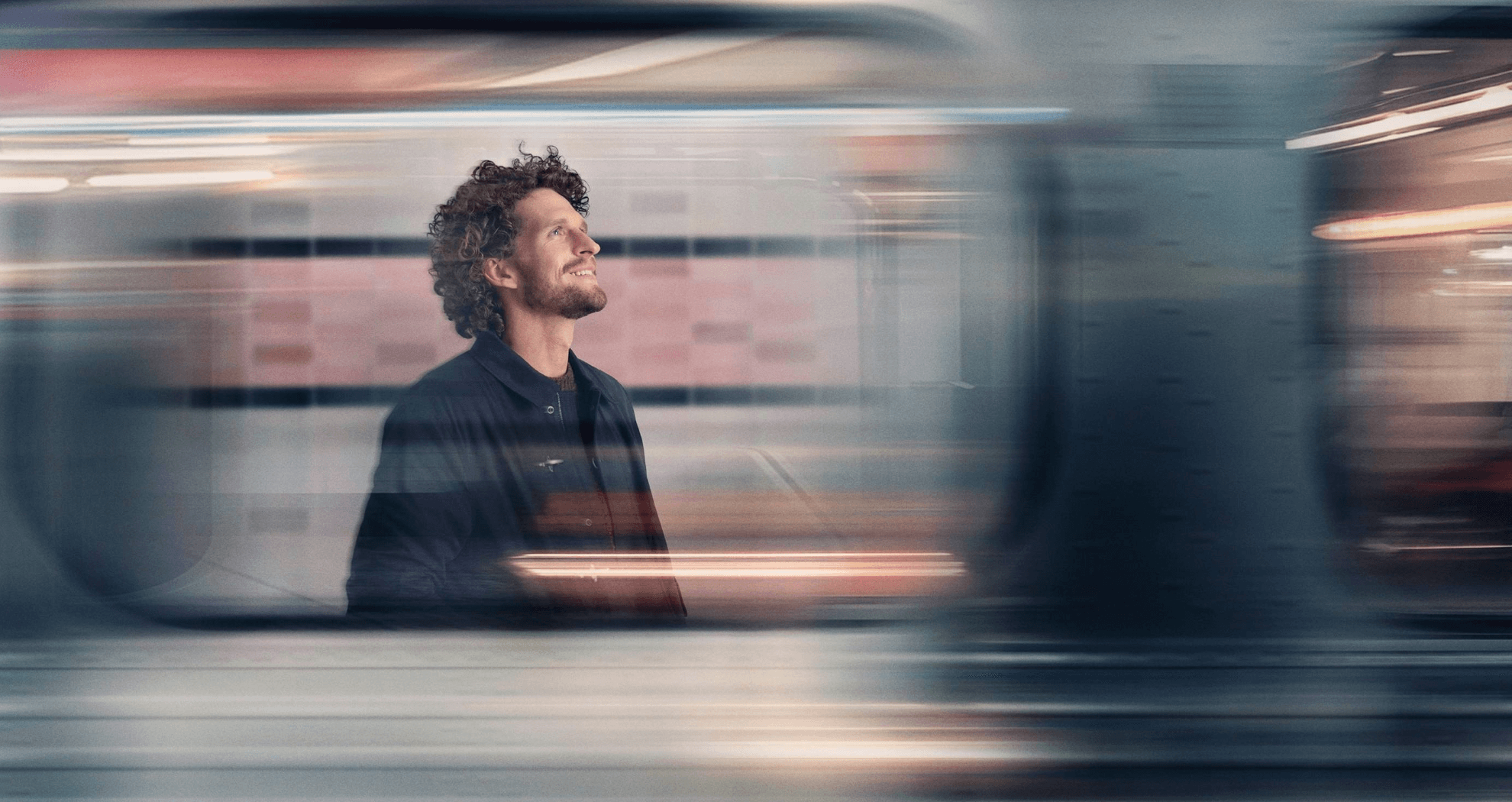 man standing on train